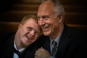 two man smiling on focus photography