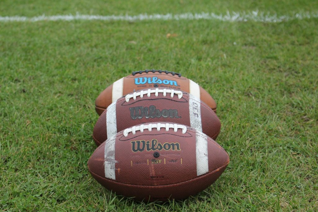 a football laying on top of a lush green field