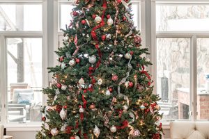 A Christmas tree on Christmas morning with presents.