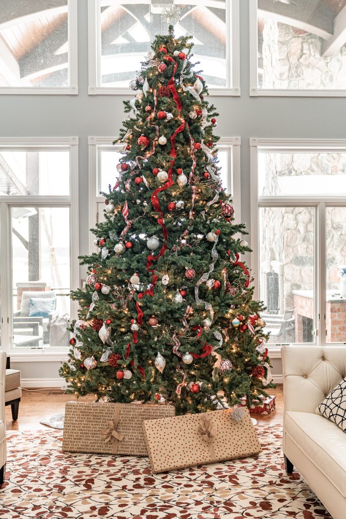 A Christmas tree on Christmas morning with presents.